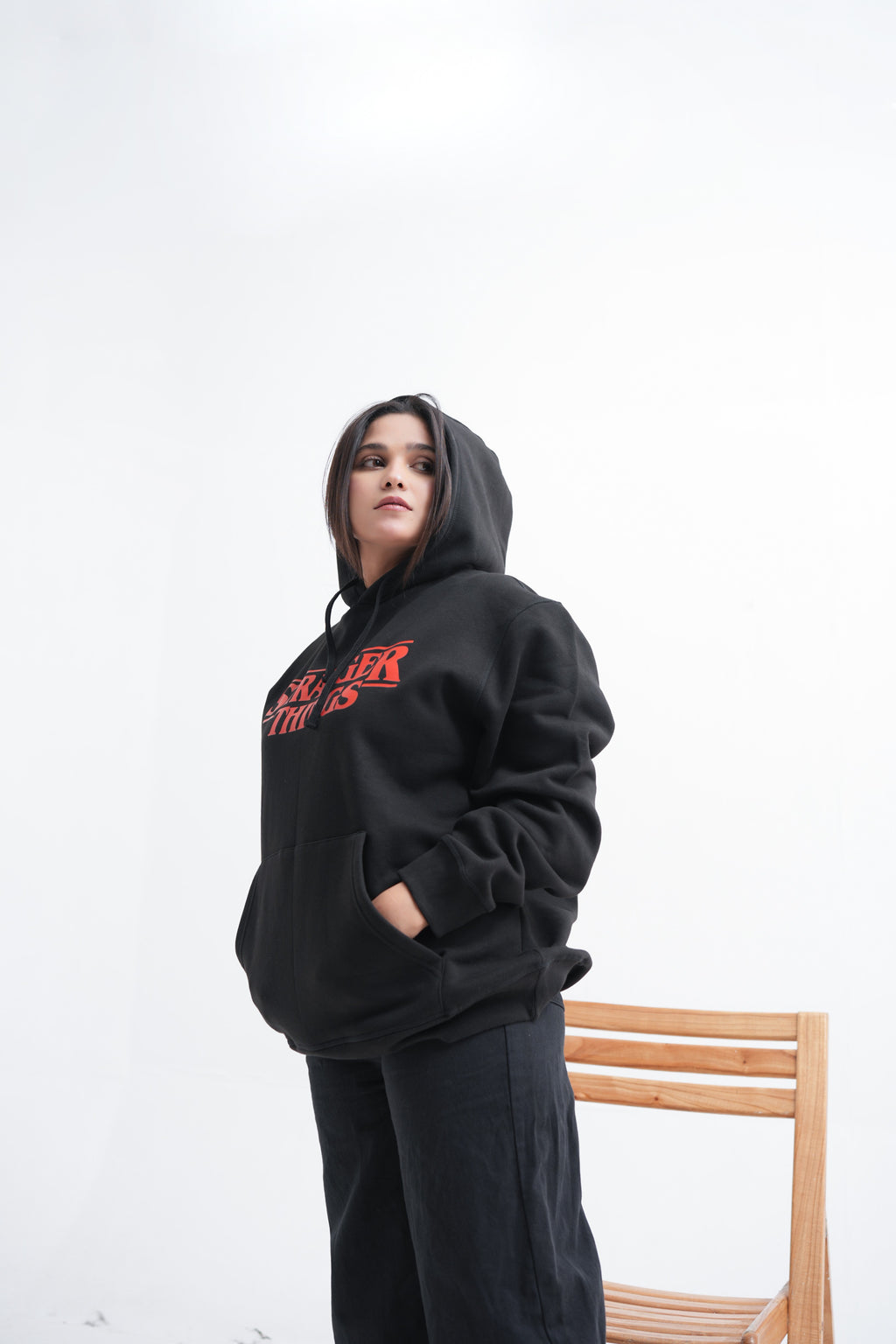 Unisex black hoodie with a Stranger Things graphic on the chest: