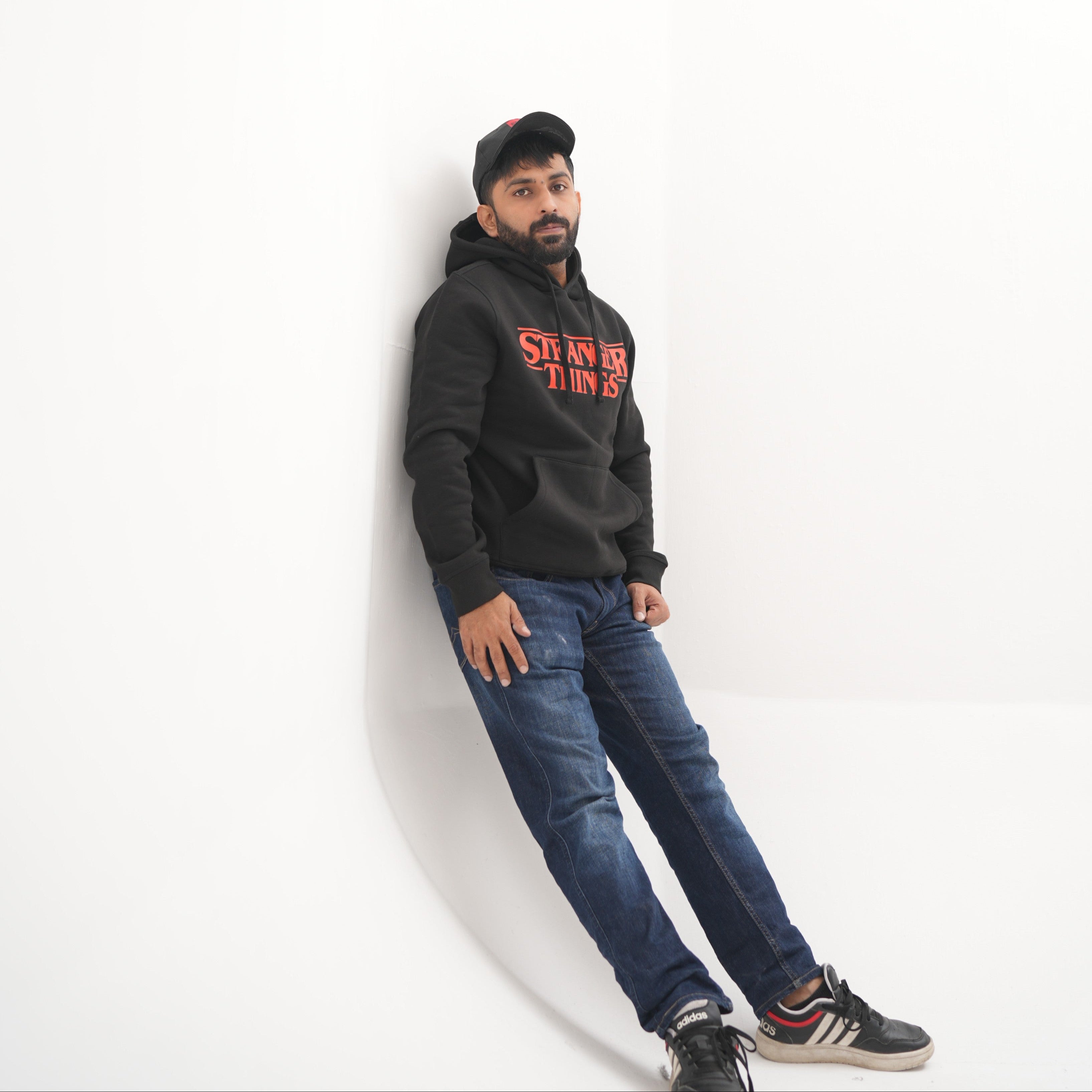 Unisex black hoodie with a Stranger Things graphic on the chest: